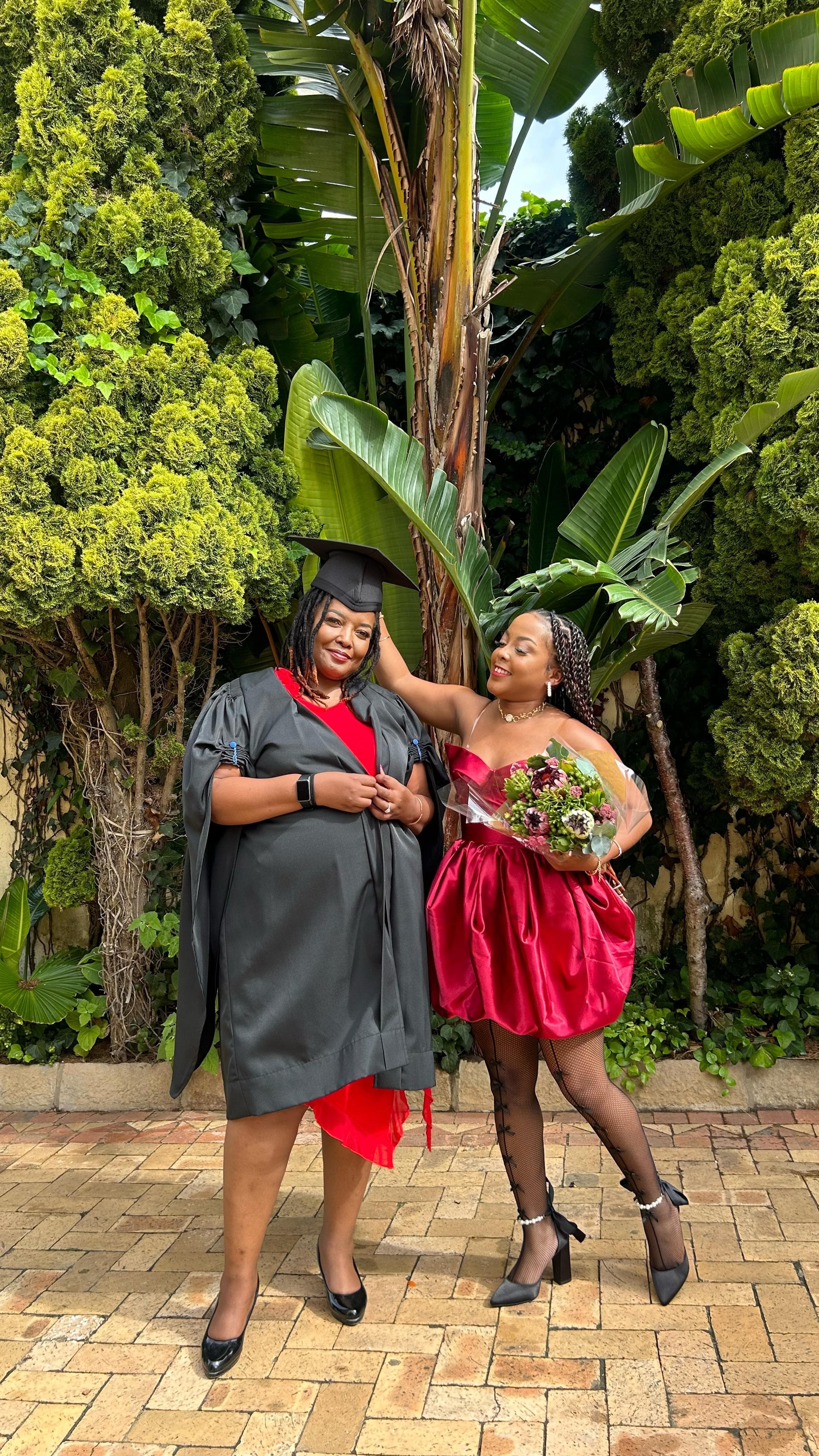 Nanda and her mother at graduation — lineage, one generation lifting the next.